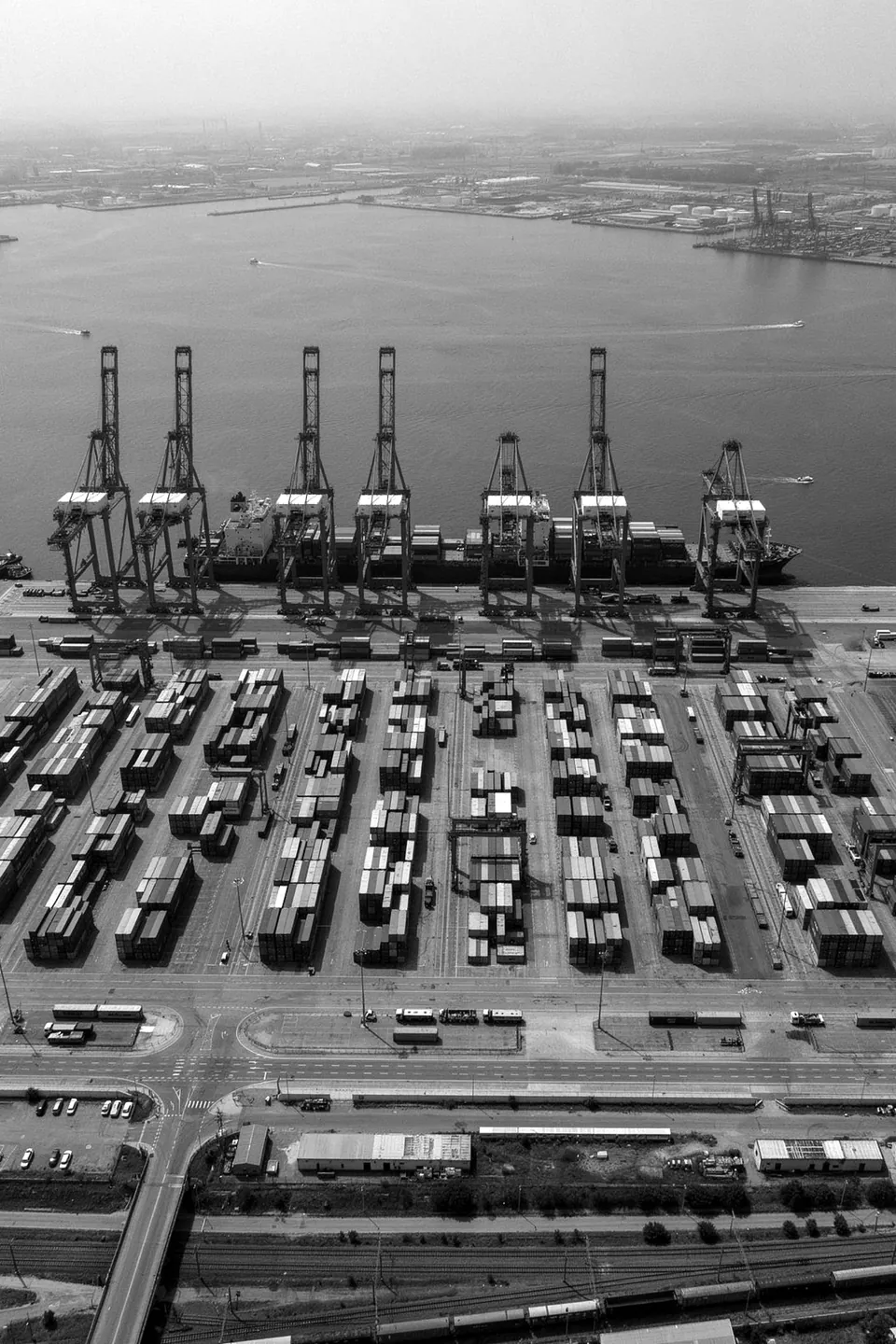 Aerial view of a container terminal with ship-to-shore cranes along the quay